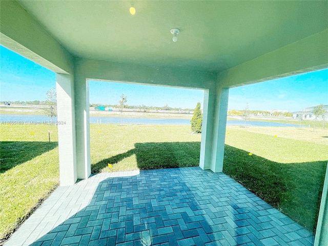 view of patio with a water view