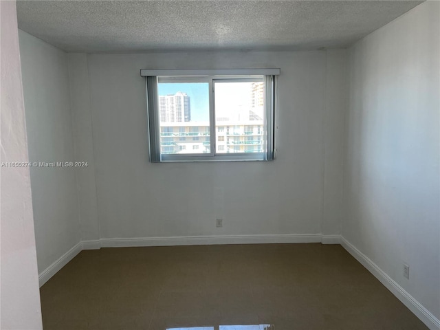 spare room featuring a textured ceiling