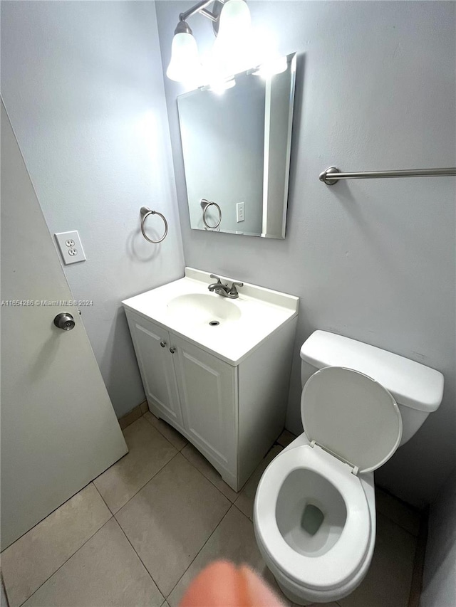 bathroom featuring vanity, toilet, and tile patterned floors