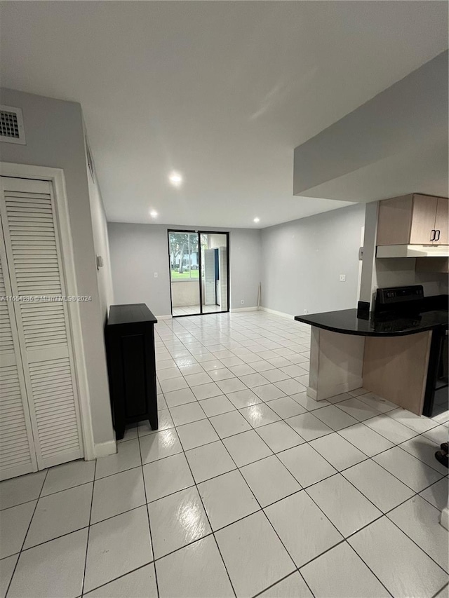 kitchen with light tile patterned floors and a kitchen bar