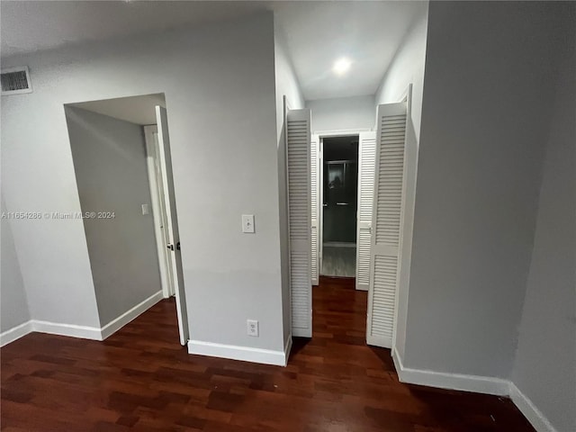 hall featuring dark wood-type flooring