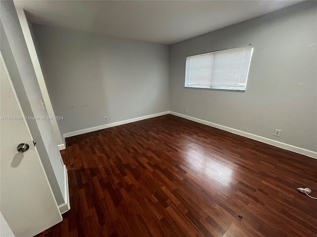 spare room featuring dark hardwood / wood-style flooring