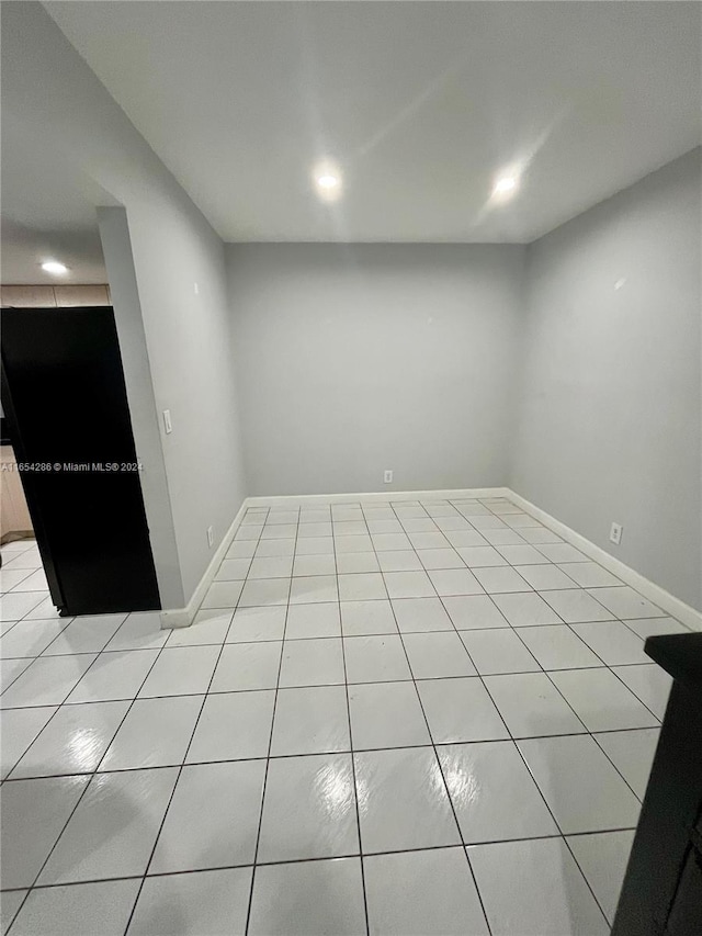 spare room featuring light tile patterned flooring