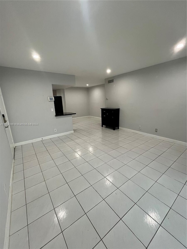 unfurnished living room with light tile patterned floors