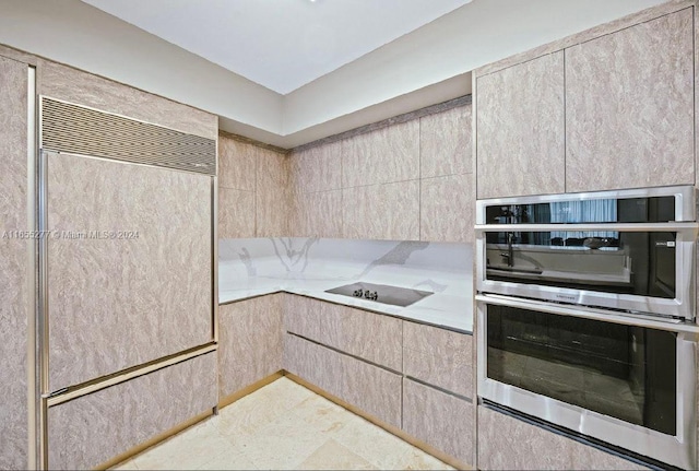 kitchen featuring stainless steel double oven, light brown cabinetry, and black electric stovetop