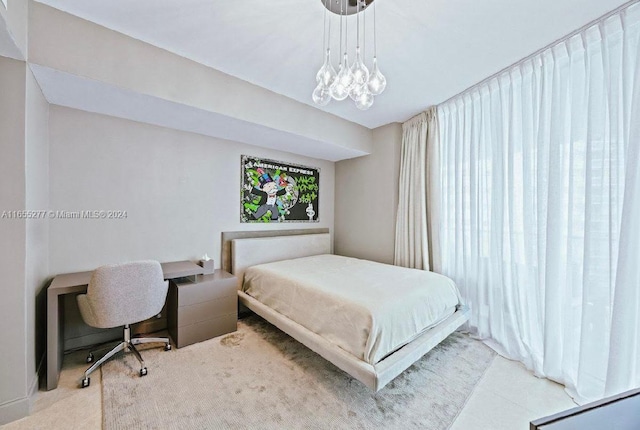 carpeted bedroom with an inviting chandelier