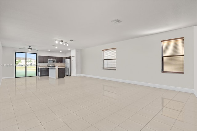 unfurnished living room featuring ceiling fan and light tile patterned flooring