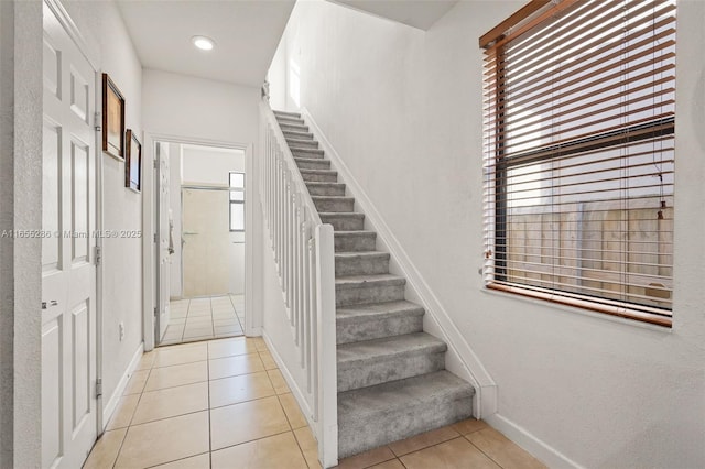 stairs featuring tile patterned flooring