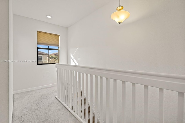 hallway with light colored carpet