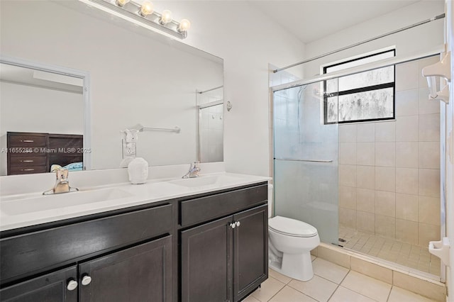 bathroom with vanity, toilet, a shower with shower door, and tile patterned flooring