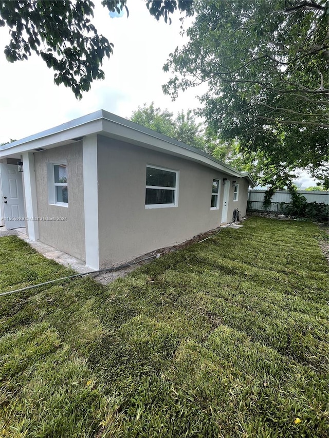 view of property exterior with a yard