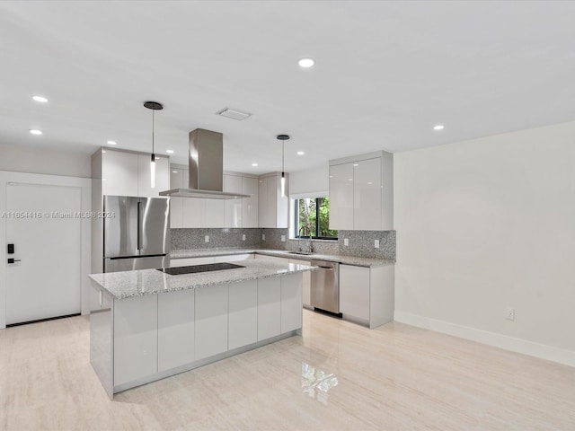 kitchen with a kitchen island, decorative light fixtures, appliances with stainless steel finishes, island exhaust hood, and light stone counters