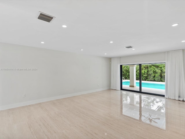 unfurnished room with light hardwood / wood-style flooring