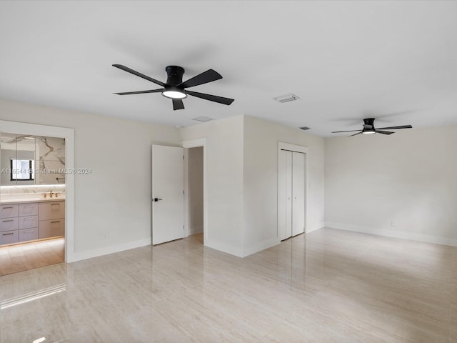 unfurnished room with light wood-type flooring, ceiling fan, and sink