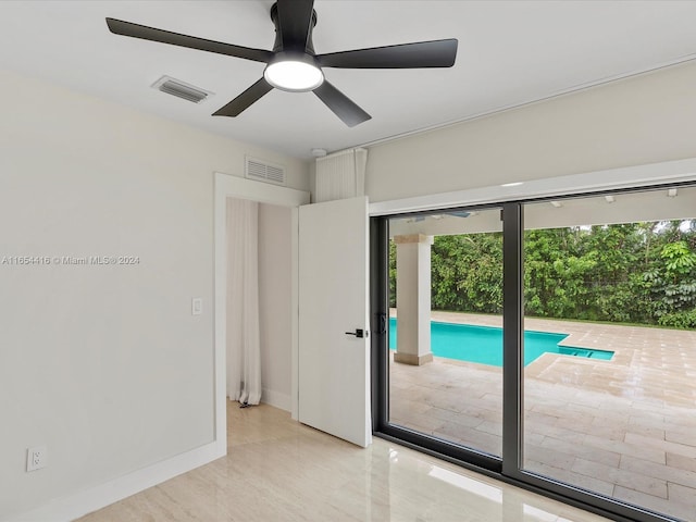 interior space with ceiling fan