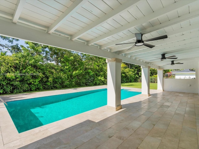 view of swimming pool with ceiling fan and a patio