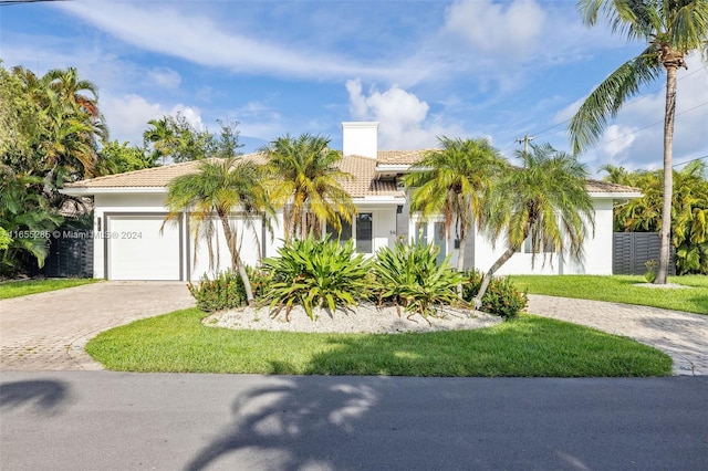 view of front facade with a front yard and a garage