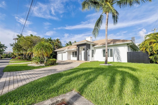 view of front of house with a front yard and a garage