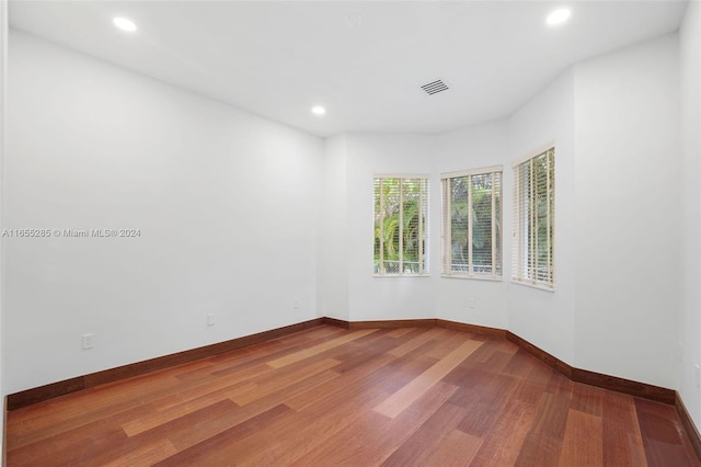 spare room featuring wood-type flooring