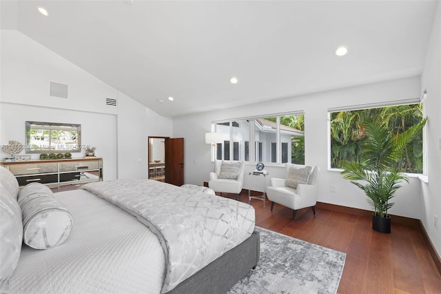 bedroom with multiple windows, dark hardwood / wood-style flooring, and high vaulted ceiling