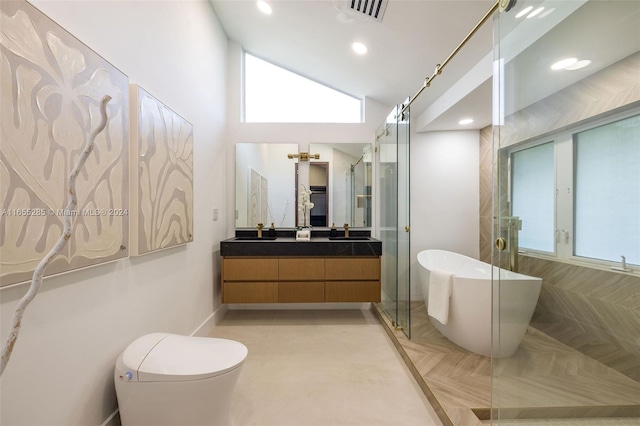 bathroom with vanity, vaulted ceiling, a wealth of natural light, and a bathing tub