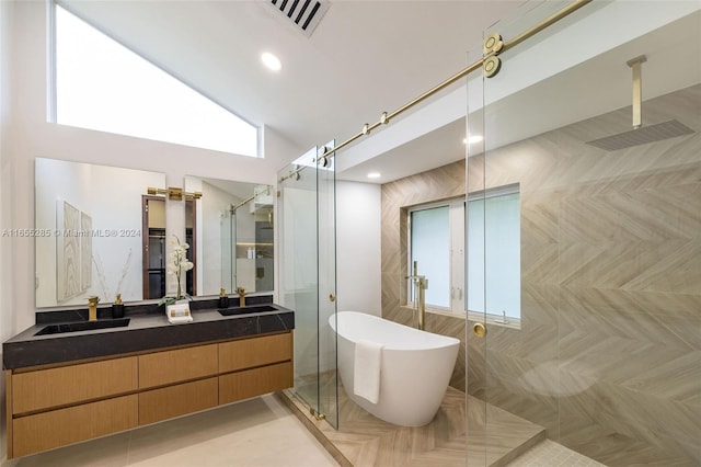 bathroom featuring parquet floors, vanity, a healthy amount of sunlight, and shower with separate bathtub