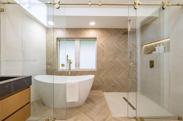 bathroom featuring separate shower and tub and vanity