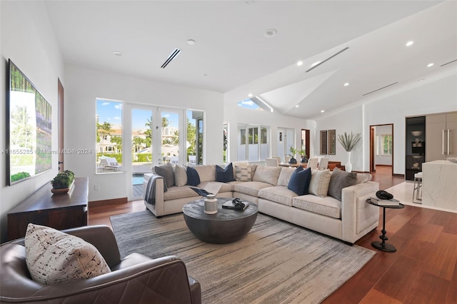 living room with dark hardwood / wood-style floors and lofted ceiling