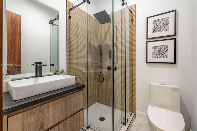 bathroom featuring vanity, toilet, and a shower with door