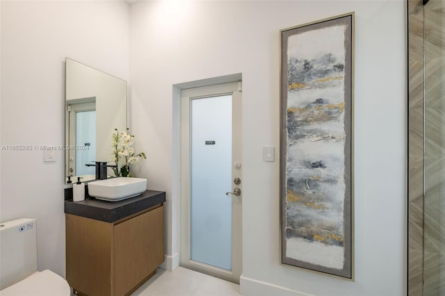 bathroom with tile patterned floors, vanity, and toilet