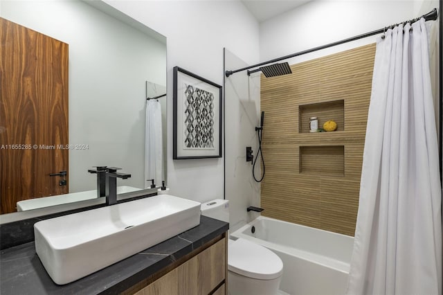 full bathroom with vanity, shower / bath combination with curtain, and toilet