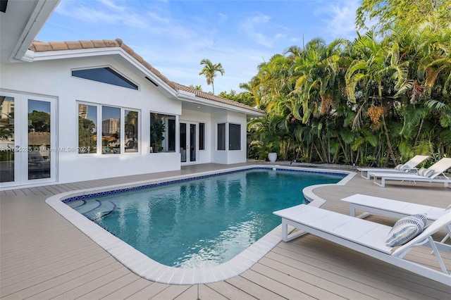 view of pool featuring a wooden deck and french doors