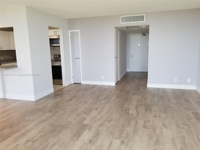 unfurnished room with light hardwood / wood-style floors