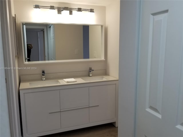 bathroom featuring hardwood / wood-style flooring and vanity