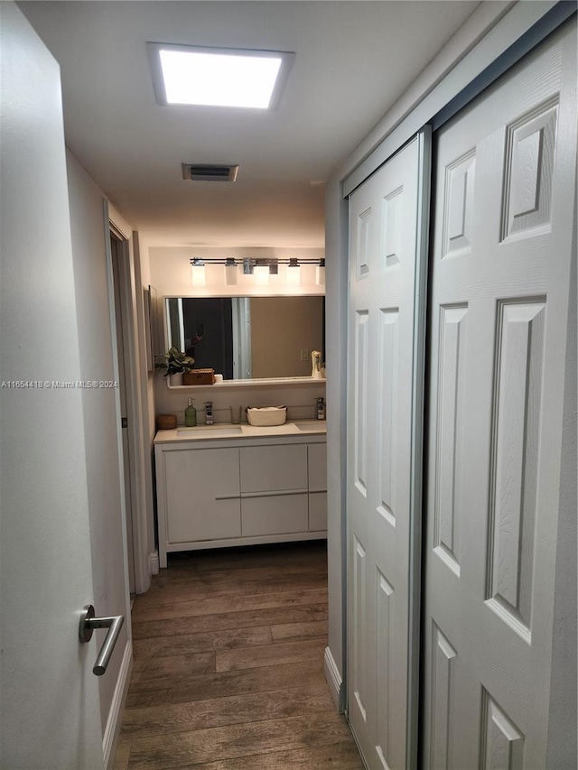 bathroom with vanity and wood-type flooring