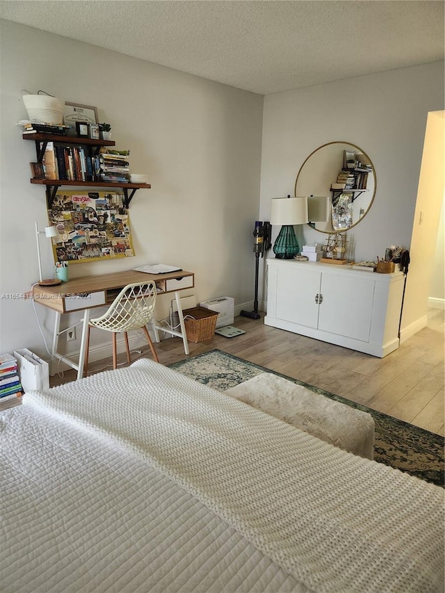 bedroom featuring hardwood / wood-style flooring and a textured ceiling