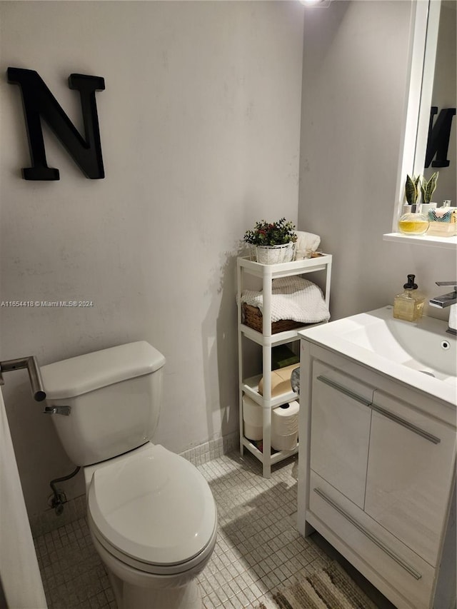 bathroom featuring tile patterned flooring, vanity, and toilet