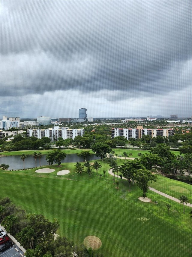 view of community with a lawn and a water view