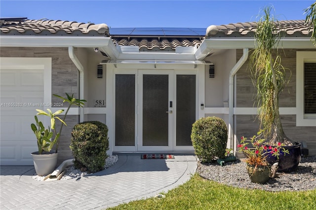 view of exterior entry with solar panels