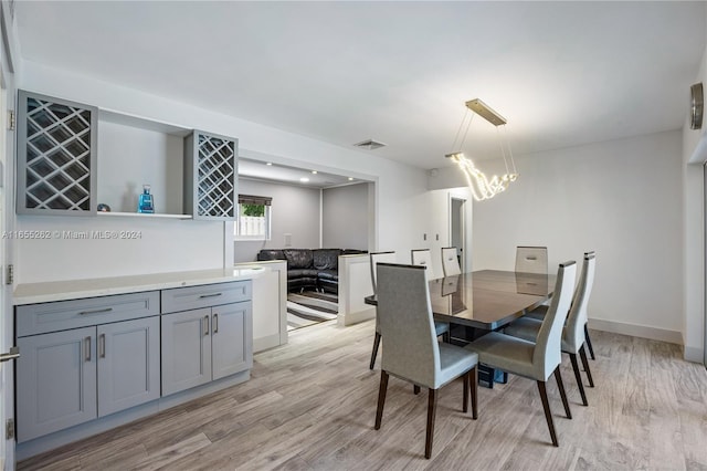 dining space with light hardwood / wood-style flooring