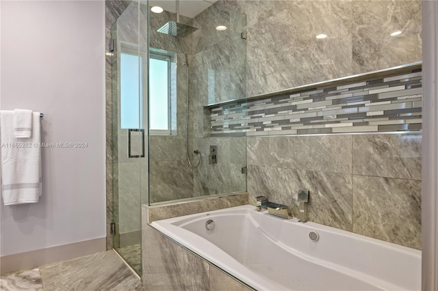 bathroom featuring shower with separate bathtub