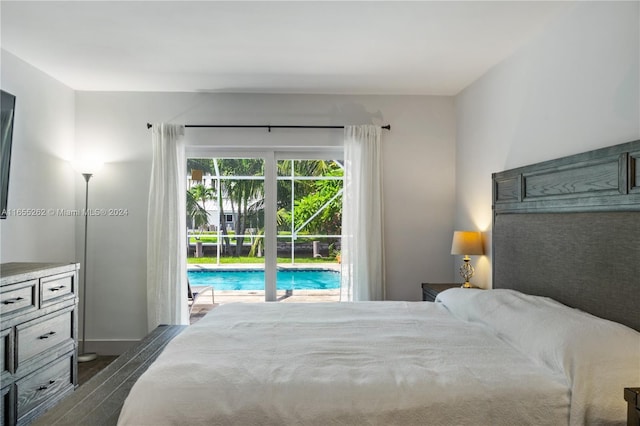 bedroom with access to exterior and dark wood-type flooring