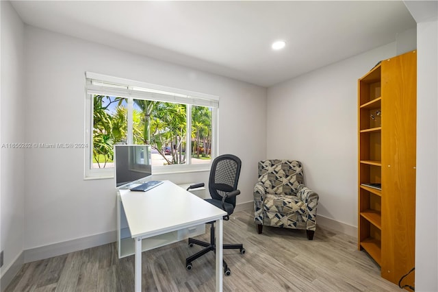 office area with light hardwood / wood-style floors