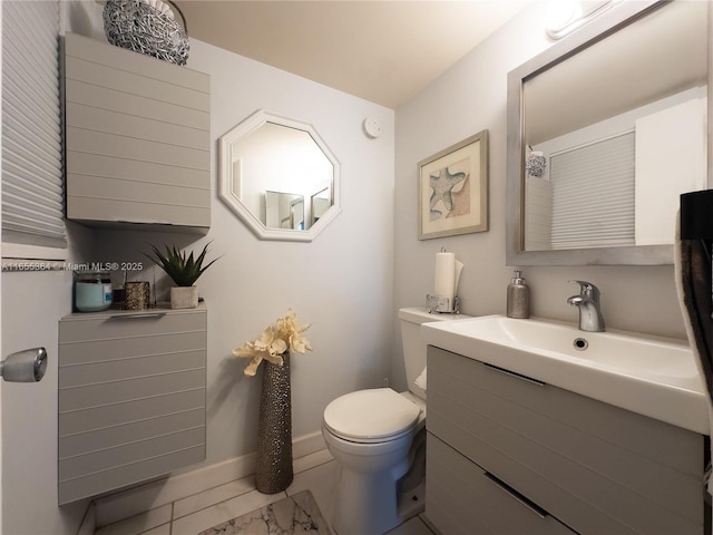 bathroom featuring vanity, toilet, and tile patterned flooring