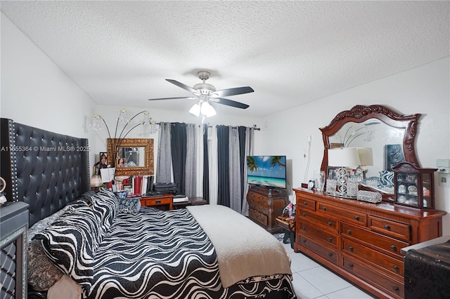 bedroom featuring light tile patterned floors, a textured ceiling, and ceiling fan