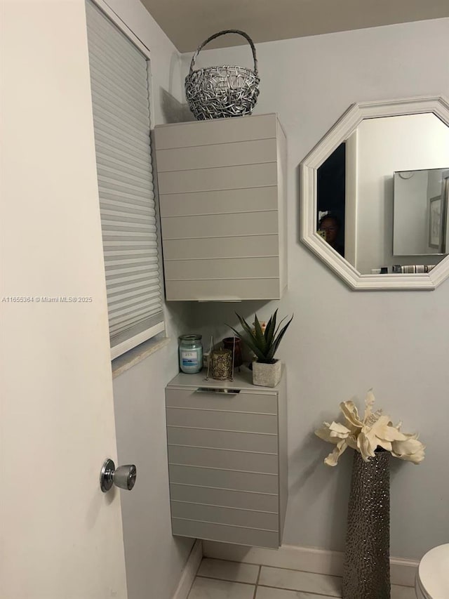 bathroom with tile patterned floors and toilet