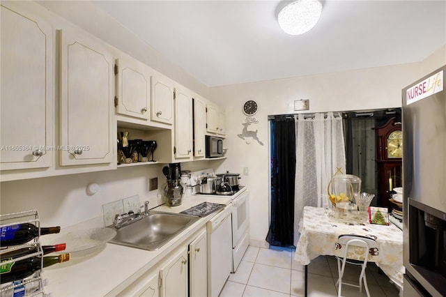 kitchen featuring sink, white appliances, and light tile patterned floors