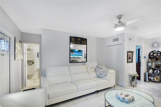 living room with ceiling fan and light tile patterned flooring