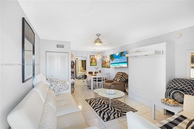 tiled living room featuring ceiling fan