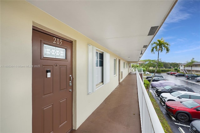 view of exterior entry featuring a balcony